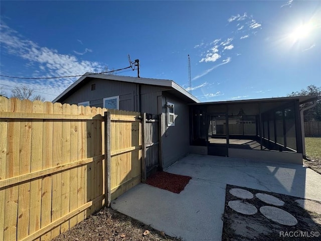 exterior space featuring a patio area and a sunroom