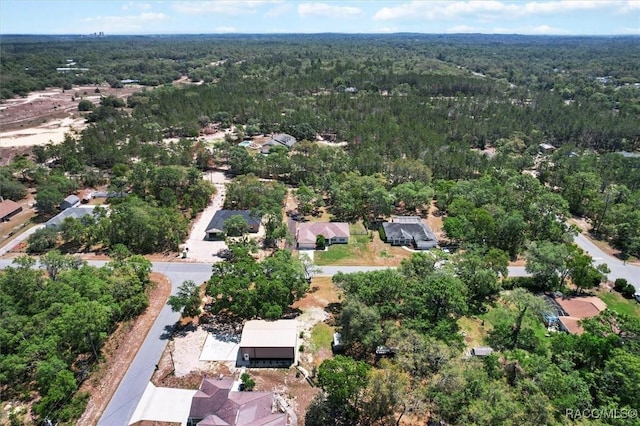 drone / aerial view with a wooded view
