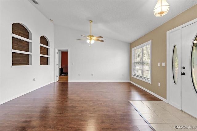 entrance foyer with vaulted ceiling, wood finished floors, baseboards, and ceiling fan