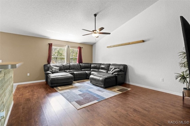 living area with wood finished floors, a textured ceiling, vaulted ceiling, ceiling fan, and baseboards