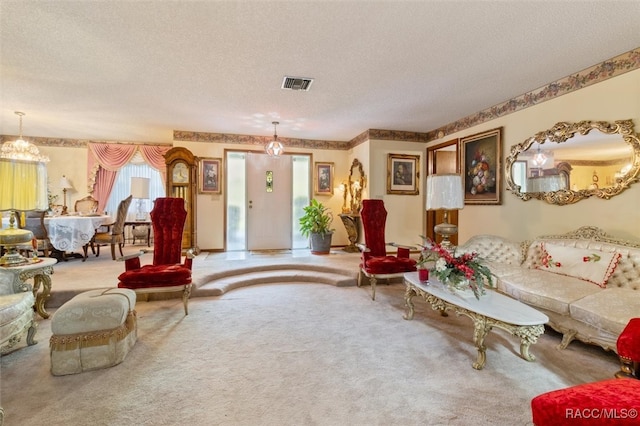 carpeted living room with a textured ceiling