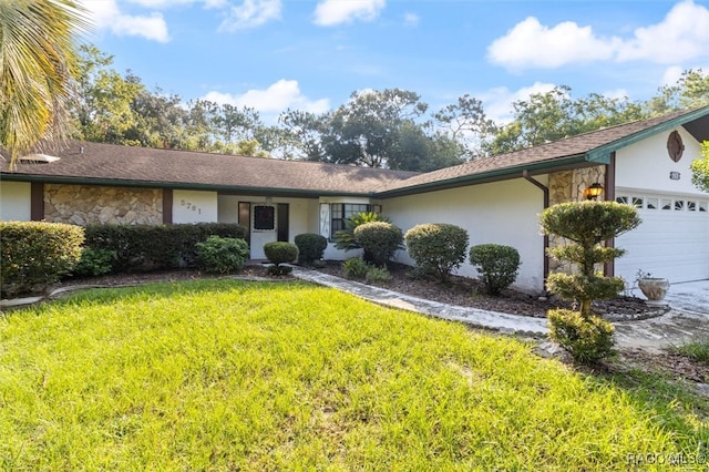 ranch-style house featuring a garage and a front lawn