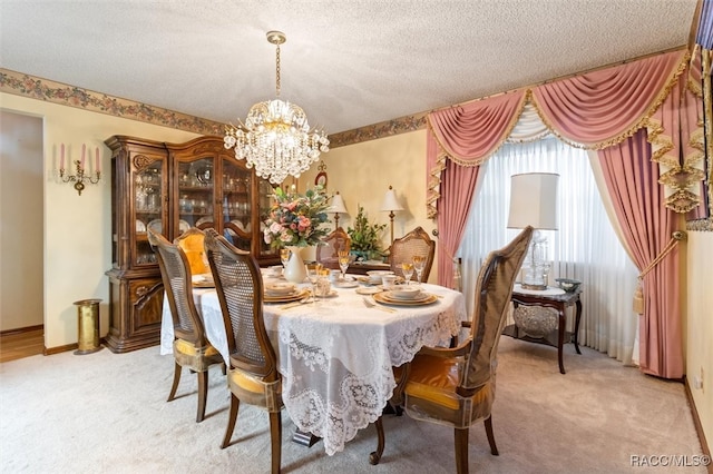 dining area with light colored carpet, a textured ceiling, and an inviting chandelier