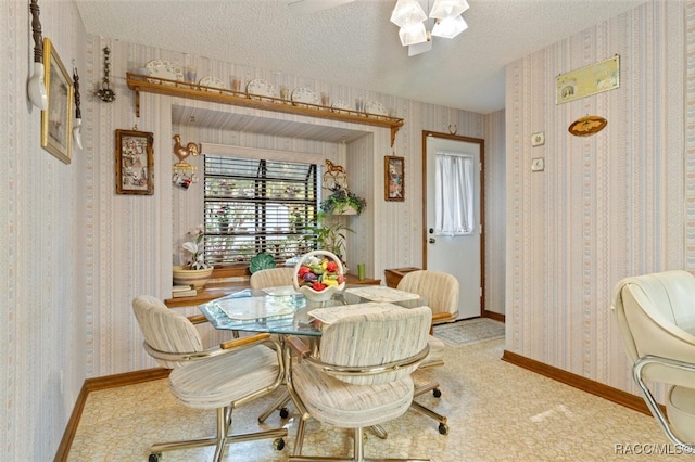 dining space featuring light colored carpet and a textured ceiling