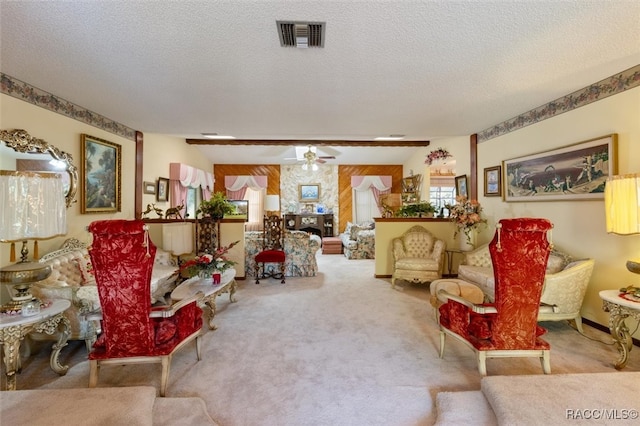 living room featuring light carpet, a textured ceiling, and ceiling fan