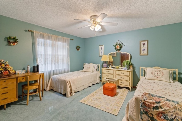 carpeted bedroom with a textured ceiling and ceiling fan