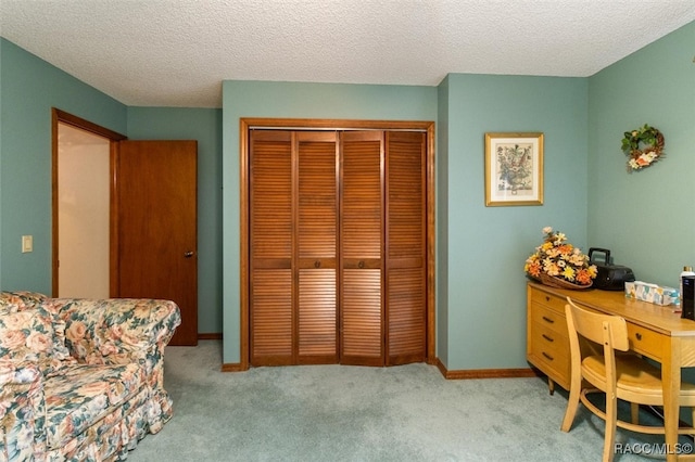 carpeted office with a textured ceiling