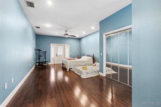 bedroom with ceiling fan, hardwood / wood-style floors, visible vents, and baseboards