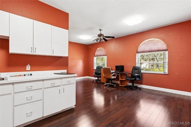 office space with dark wood-style floors, baseboards, and a ceiling fan