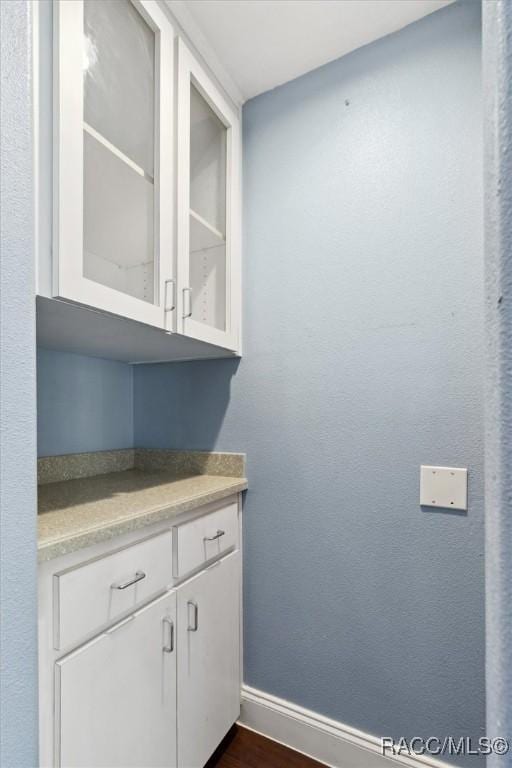 interior space featuring dark wood-style floors and baseboards