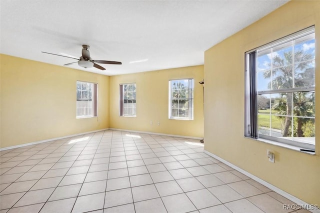 unfurnished room featuring light tile patterned floors, baseboards, and a healthy amount of sunlight