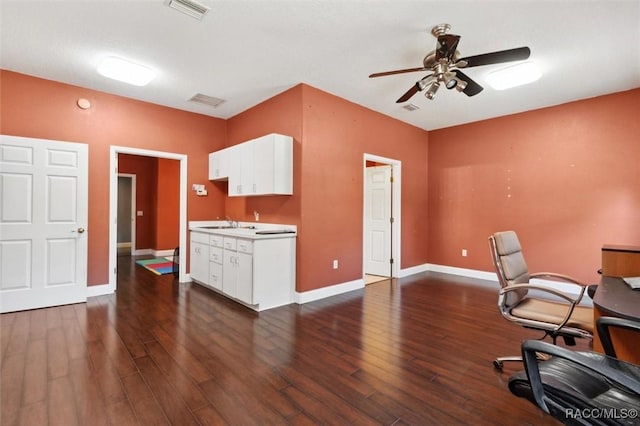 office area featuring ceiling fan, dark wood-style flooring, visible vents, and baseboards