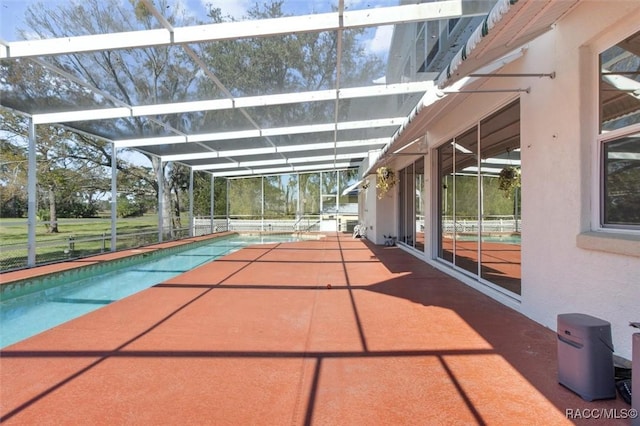 pool with glass enclosure and a patio