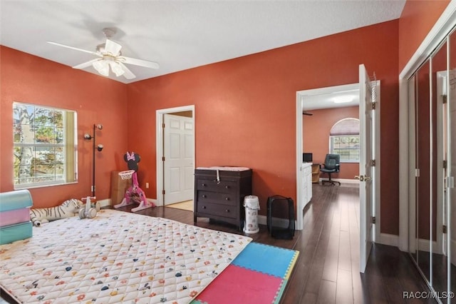 bedroom with ceiling fan, baseboards, and wood finished floors