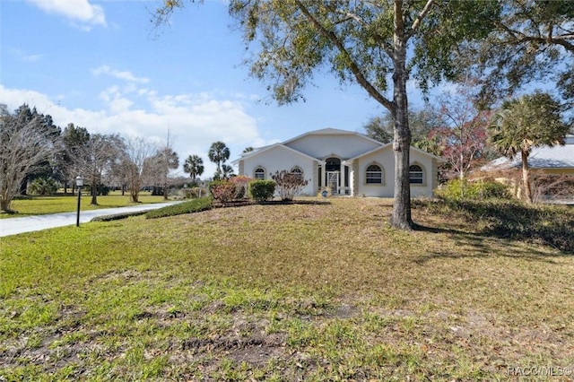 view of front of house with a front lawn and stucco siding