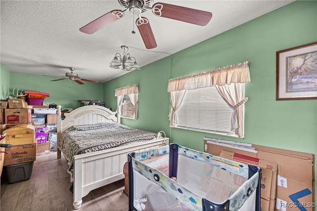 22535 SW 117th St, Dunnellon, FL 34431 - bedroom featuring wood finished floors, a textured ceiling, and a ceiling fan
