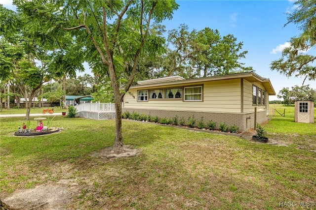 22535 SW 117th St, Dunnellon, FL 34431 - view of front of home with a front yard, a deck, and brick siding