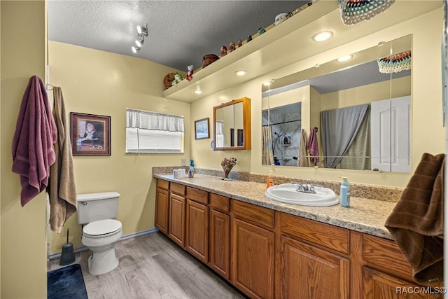 22535 SW 117th St, Dunnellon, FL 34431 - full bath with double vanity, wood finished floors, a shower, and a textured ceiling