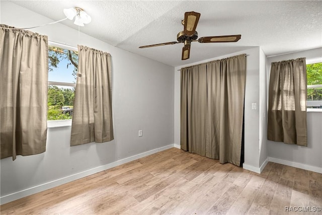 22535 SW 117th St, Dunnellon, FL 34431 - empty room with light wood finished floors, a textured ceiling, and ceiling fan
