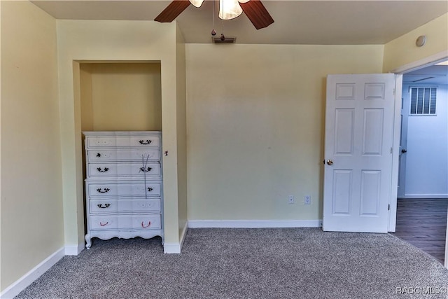 unfurnished bedroom featuring ceiling fan and dark colored carpet