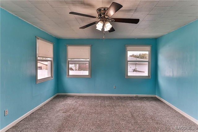 carpeted spare room featuring ceiling fan