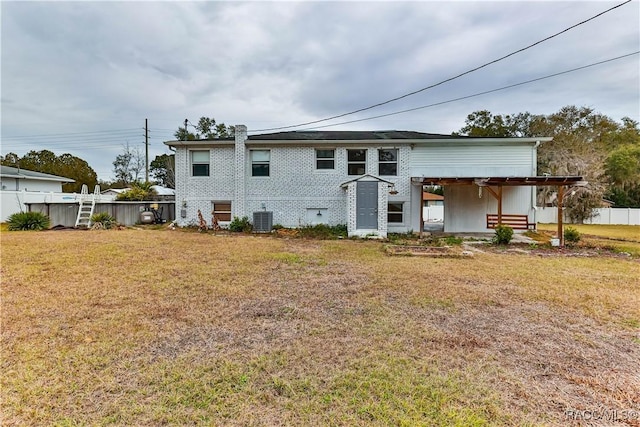 view of front of home with a front yard and cooling unit