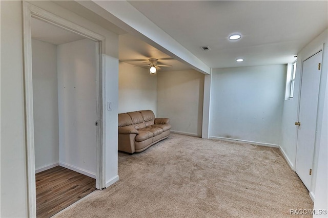 unfurnished living room with ceiling fan and light carpet