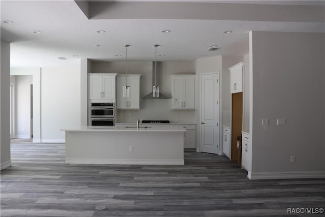 6392 Summit View Dr, Brooksville, FL 34604 - kitchen featuring recessed lighting, wood finished floors, wall chimney range hood, and baseboards