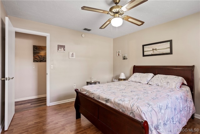 bedroom featuring ceiling fan and dark hardwood / wood-style floors