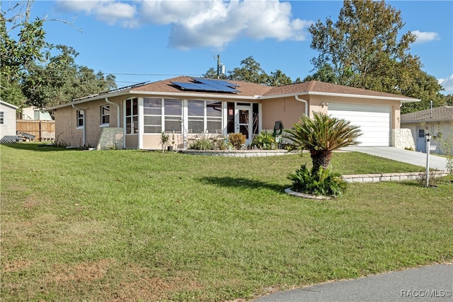 ranch-style home featuring solar panels, a garage, a front lawn, and a sunroom