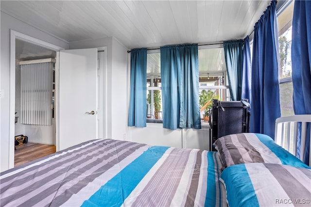 bedroom with hardwood / wood-style flooring and wooden ceiling