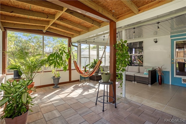 unfurnished sunroom featuring vaulted ceiling