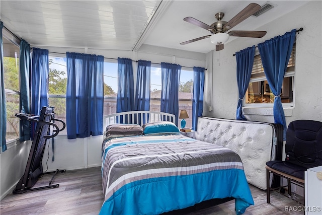 bedroom with hardwood / wood-style floors and ceiling fan