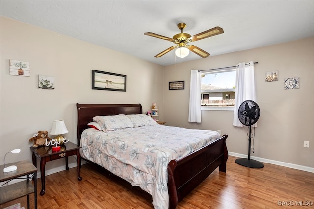 bedroom featuring hardwood / wood-style floors and ceiling fan