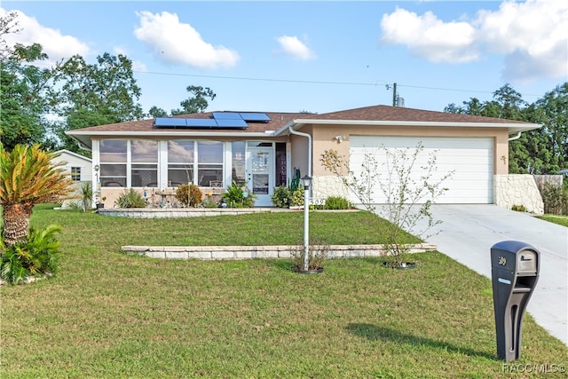 single story home featuring solar panels, a garage, and a front lawn