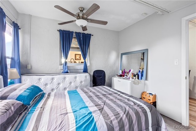 bedroom with wood-type flooring and ceiling fan