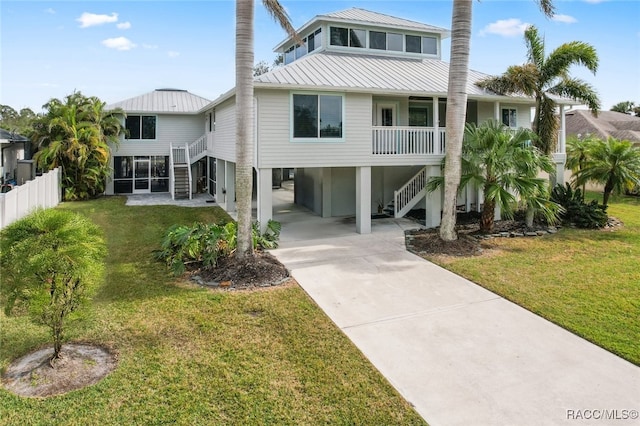 rear view of house featuring a yard and a carport