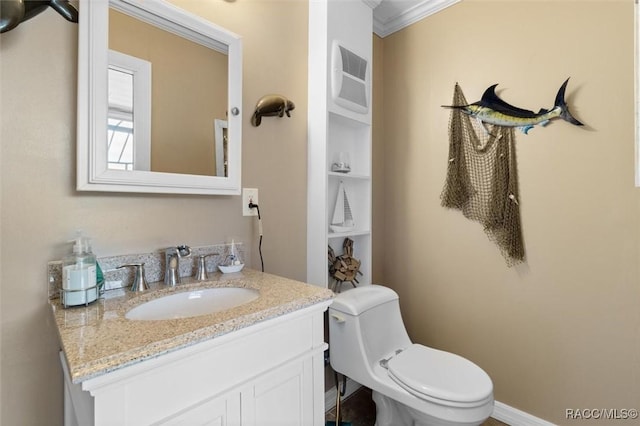 bathroom with toilet, crown molding, and vanity