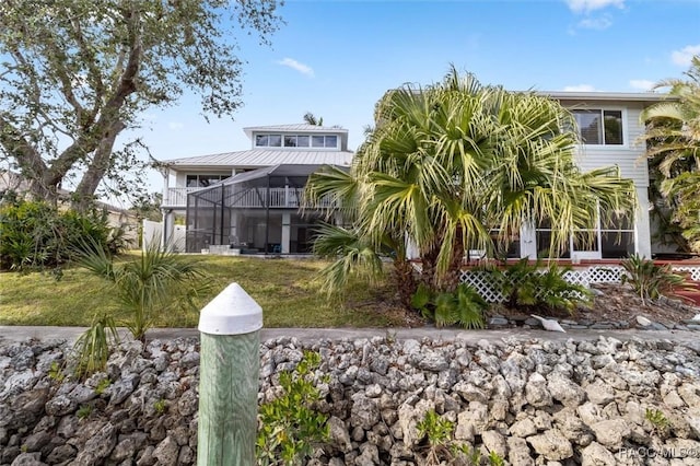 rear view of property featuring a lanai