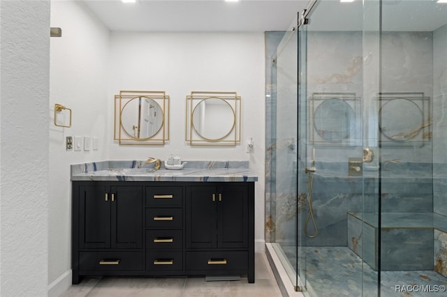 bathroom featuring vanity and an enclosed shower