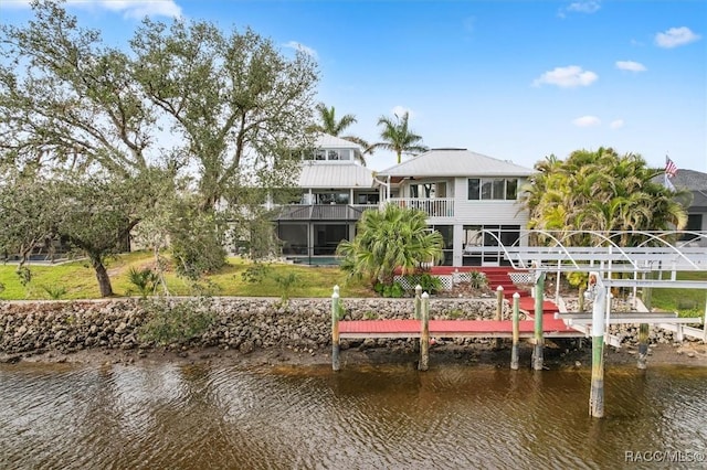 view of dock featuring a water view and a balcony