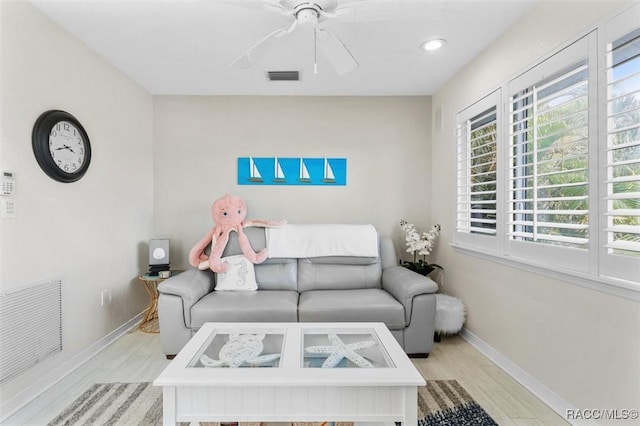 living room featuring ceiling fan and light wood-type flooring