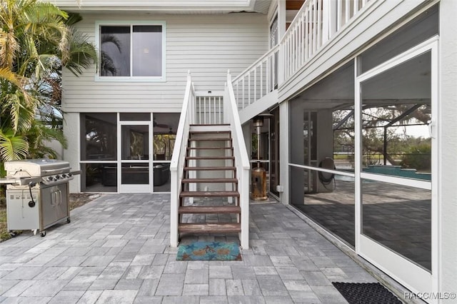 view of patio / terrace with a lanai, a sunroom, and grilling area