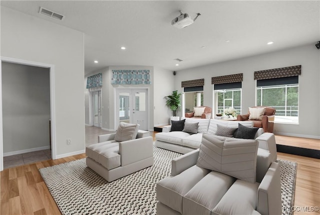 living room featuring french doors and light wood-type flooring