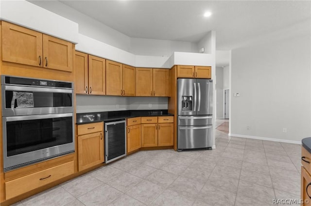 kitchen featuring stainless steel appliances and beverage cooler