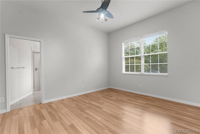 empty room with ceiling fan and light wood-type flooring