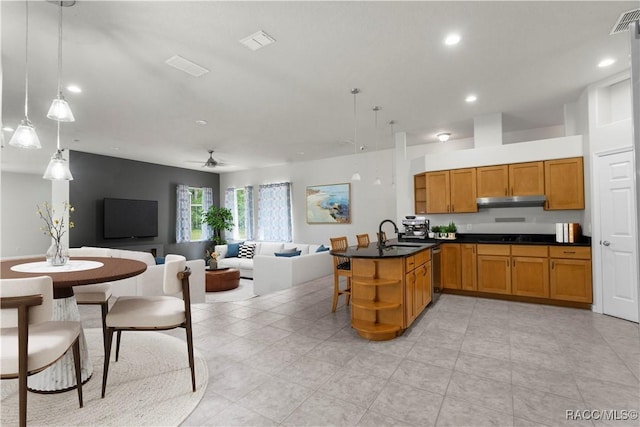 kitchen featuring sink, decorative light fixtures, stainless steel dishwasher, kitchen peninsula, and ceiling fan