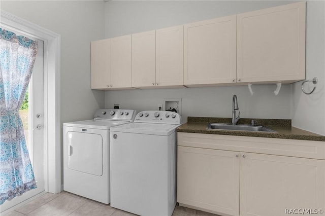 washroom featuring cabinets, washer and dryer, sink, and light tile patterned floors