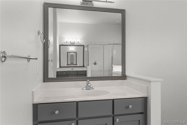 bathroom with vanity and a shower with door