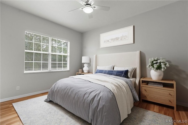 bedroom with hardwood / wood-style floors and ceiling fan